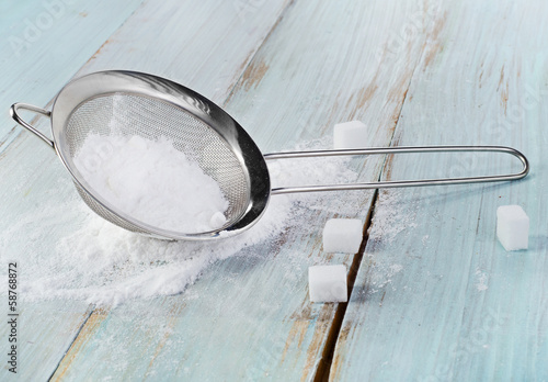 Photo: Powdered sugar in a metal sieve Powdered sugar in a metal sieve