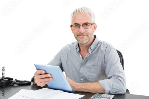 Photo: Portrait of a mature businessman with digital tablet and telepho Portrait of a mature businessman with digital tablet and telepho