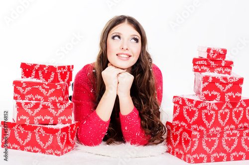 Photo: smiling woman with many gift boxes isolated on white smiling woman with many gift boxes isolated on white