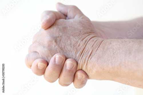 Photo: clasped hands of older man clasped hands of older man