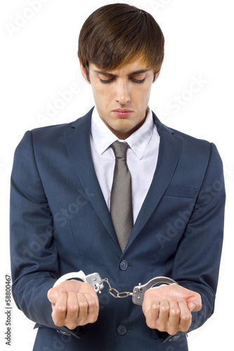 Photo: young Caucasian male arrested for tax evasion young Caucasian male arrested for tax evasion