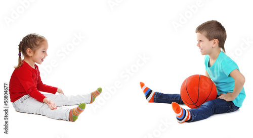 Photo: Little children playing with ball isolated on white Little children playing with ball isolated on white