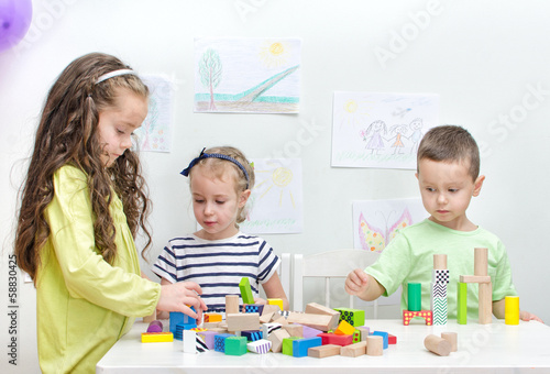 Photo: Children playing with blocks in kindergarten Children playing with blocks in kindergarten