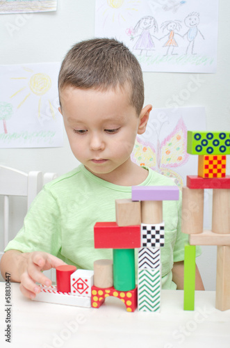 Photo: Boy playing with blocks in kindergarten Boy playing with blocks in kindergarten