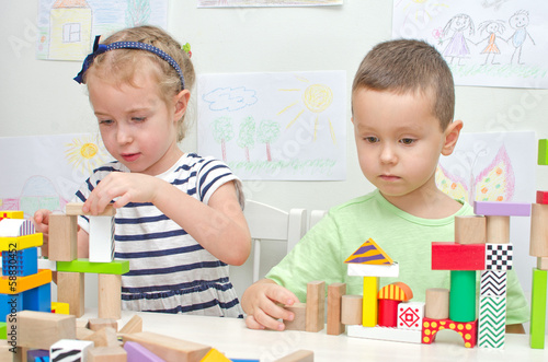 Photo: Children playing with blocks in kindergarten Children playing with blocks in kindergarten