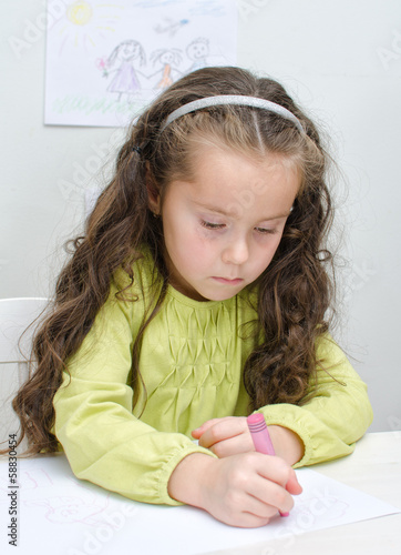 Photo: Little girl drawing with crayons Little girl drawing with crayons