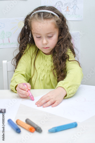 Photo: Little girl drawing with crayons Little girl drawing with crayons