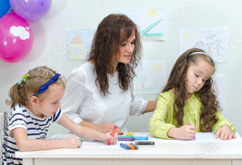 Photo: Teacher with two girls in kindergarten. Teacher with two girls in kindergarten.