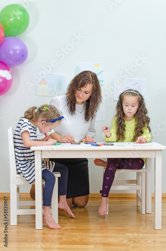 Photo: Teacher with two girls in kindergarten. Teacher with two girls in kindergarten.
