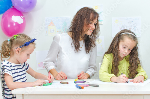 Photo: Teacher with two girls in kindergarten. Teacher with two girls in kindergarten.