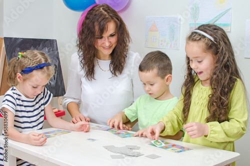 Photo: Teacher plays with children in kindergarten. Teacher plays with children in kindergarten.