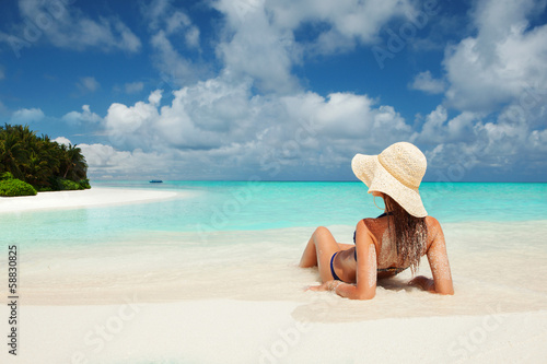 Photo: Young fashion woman relax on the beach Young fashion woman relax on the beach