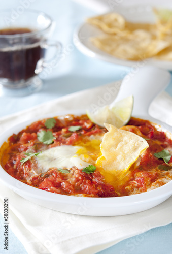Photo: partially eaten Huevos Rancheros breakfast with coffee. partially eaten Huevos Rancheros breakfast with coffee.