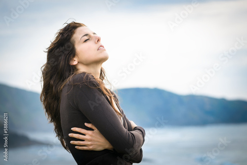 Photo: Shivery woman feeling the breeze Shivery woman feeling the breeze