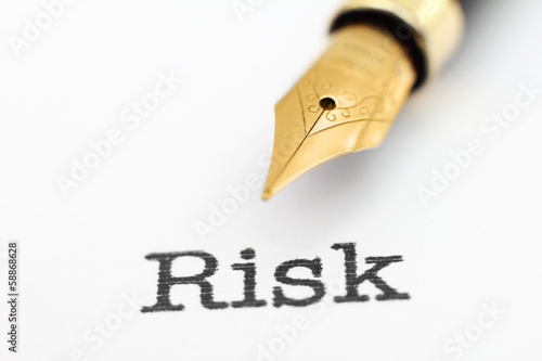 Photo: Fountain pen on risk text Fountain pen on risk text