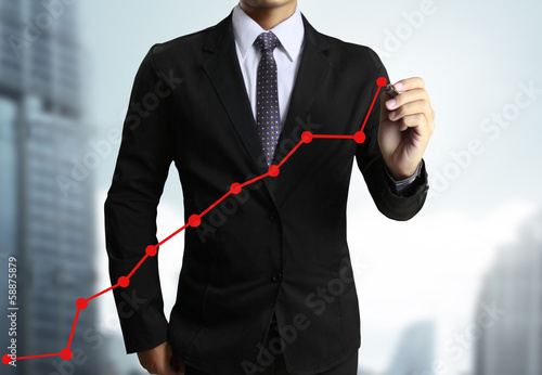 Photo: Business man hand drawing graph Business man hand drawing graph