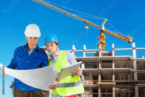 Photo: Foreman and engineer with blueprints Foreman and engineer with blueprints
