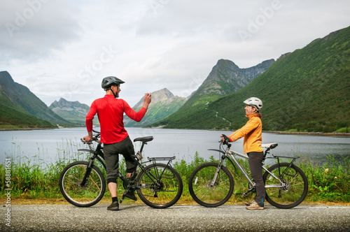 Photo: two cyclists relax biking two cyclists relax biking