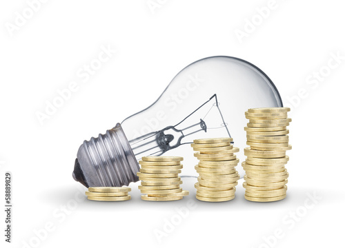 Photo: Light bulb and coins. Isolated on white background Light bulb and coins. Isolated on white background
