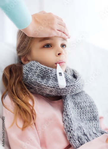 Photo: ill girl child with thermometer and caring mother ill girl child with thermometer and caring mother