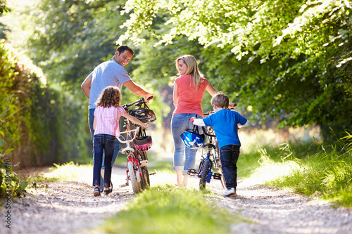 Photo: Family Pushing Bikes Along Country Track Family Pushing Bikes Along Country Track