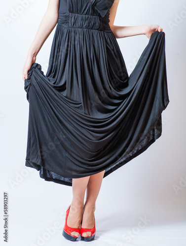 Photo: redhead waist down body in black dress,studio shot redhead waist down body in black dress,studio shot