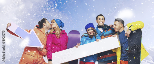 Photo: Laughing group of snowboarders with the snowing background Laughing group of snowboarders with the snowing background