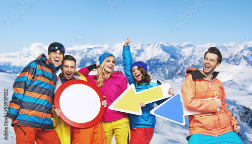 Photo: Cheerful snowboarders with funy signs Cheerful snowboarders with funy signs