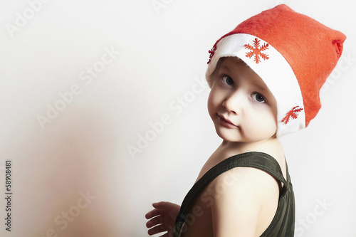 Photo: little boy in red Santa hat.Christmas.your text here little boy in red Santa hat.Christmas.your text here