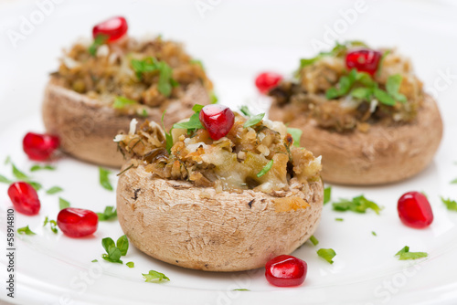 Photo: Stuffed mushrooms with herbs and pomegranate, close-up Stuffed mushrooms with herbs and pomegranate, close-up