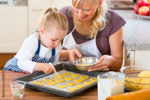 Photo: Mother and daughter baking cookies together Mother and daughter baking cookies together