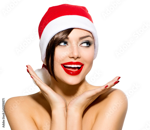 Photo: Christmas Woman. Beauty Model Girl in Santa Hat over White Christmas Woman. Beauty Model Girl in Santa Hat over White