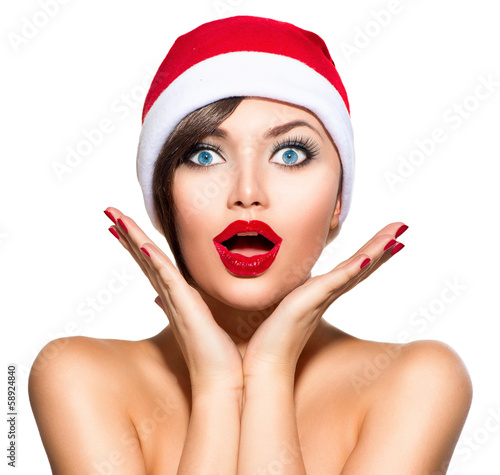 Photo: Christmas Woman. Beauty Model Girl in Santa Hat over White Christmas Woman. Beauty Model Girl in Santa Hat over White