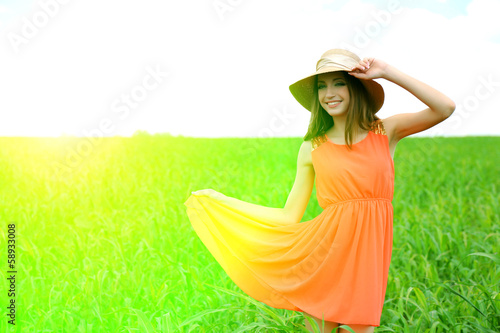 Photo: Portrait of beautiful young woman in the field Portrait of beautiful young woman in the field