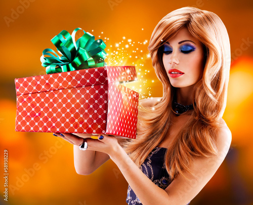 Photo: Beautiful sexy woman with a christmas gift Beautiful sexy woman with a christmas gift