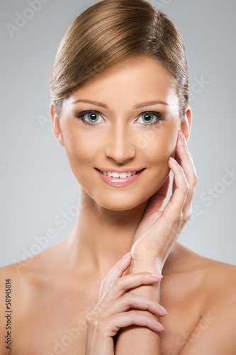 Photo: Natural looking woman is happy about her beauty Natural looking woman is happy about her beauty