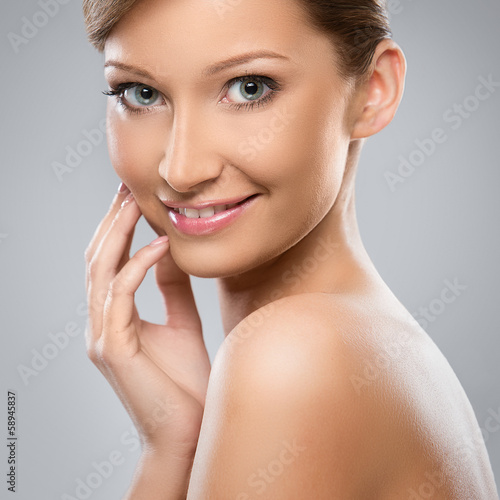 Photo: Natural looking woman is happy about her beauty Natural looking woman is happy about her beauty