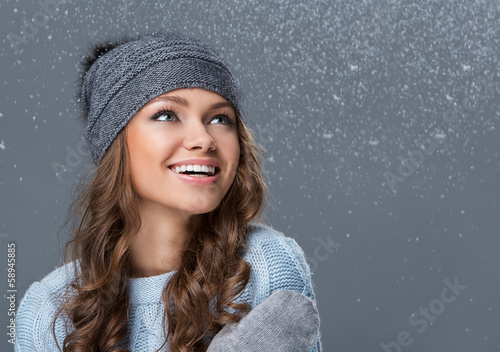 Photo: Cute girl in winter clothing with snowflakes Cute girl in winter clothing with snowflakes