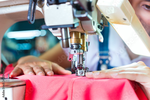 Photo: Indonesian Seamstress in Asian textile factory Indonesian Seamstress in Asian textile factory