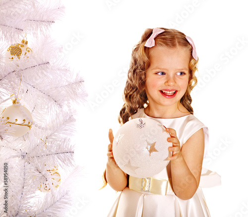 Photo: Child decorate white Christmas tree. Child decorate white Christmas tree.
