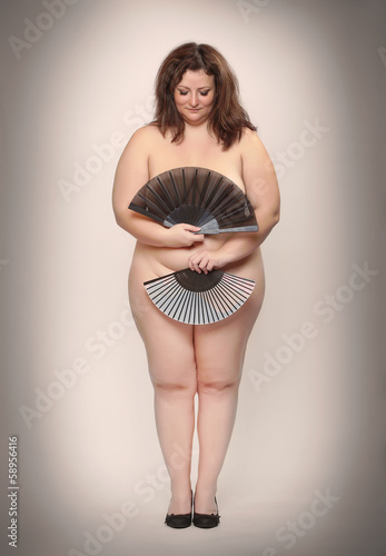 Photo: Retro picture of a naked overweight woman with oriental fan. Retro picture of a naked overweight woman with oriental fan.