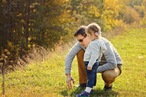 Photo: father walking with toddler daughter father walking with toddler daughter