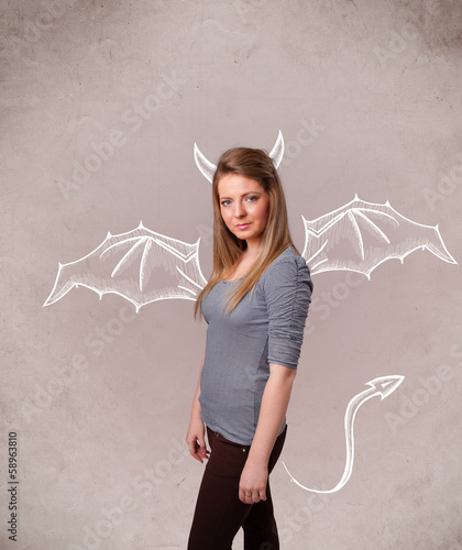 Photo: Young girl with devil horns and wings drawing Young girl with devil horns and wings drawing