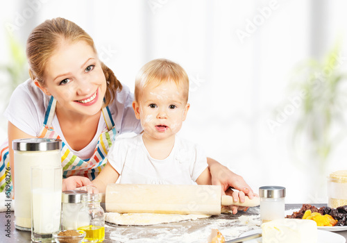 Photo: baby girl with her mother cook, bake baby girl with her mother cook, bake