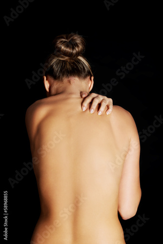 Photo: Nude, topless woman, scratching her neck. Nude, topless woman, scratching her neck.