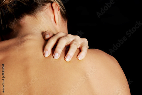 Photo: Nude, topless woman, scratching her neck. Nude, topless woman, scratching her neck.