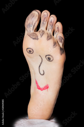 Photo: Painted funny face on the woman's feet Painted funny face on the woman's feet