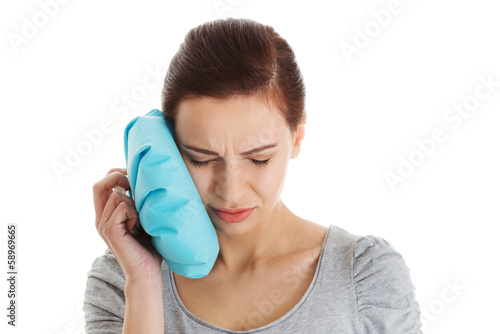 Photo: Young casual woman having a toothache. Young casual woman having a toothache.