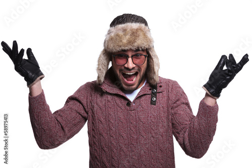 Photo: man in fur hat and winter clother is being very surprised and sc man in fur hat and winter clother is being very surprised and sc