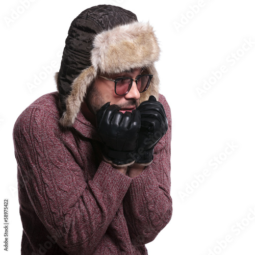 Photo: side of a young man worrying about cold weather side of a young man worrying about cold weather
